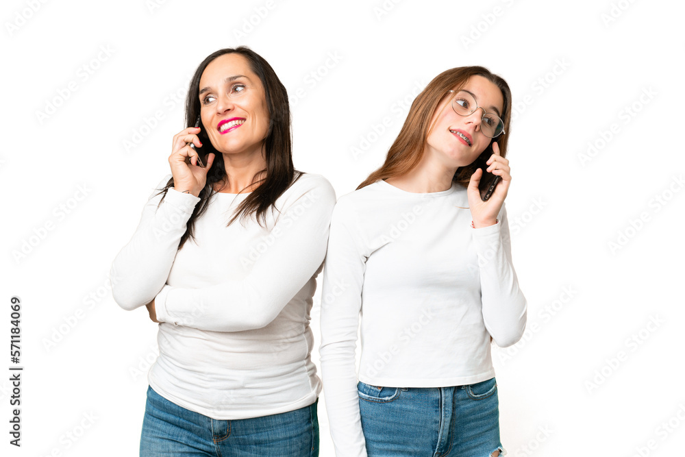 mother and daughter over isolated chroma key background talking to mobile mother and daughter over isolated chroma key background talking to mobile