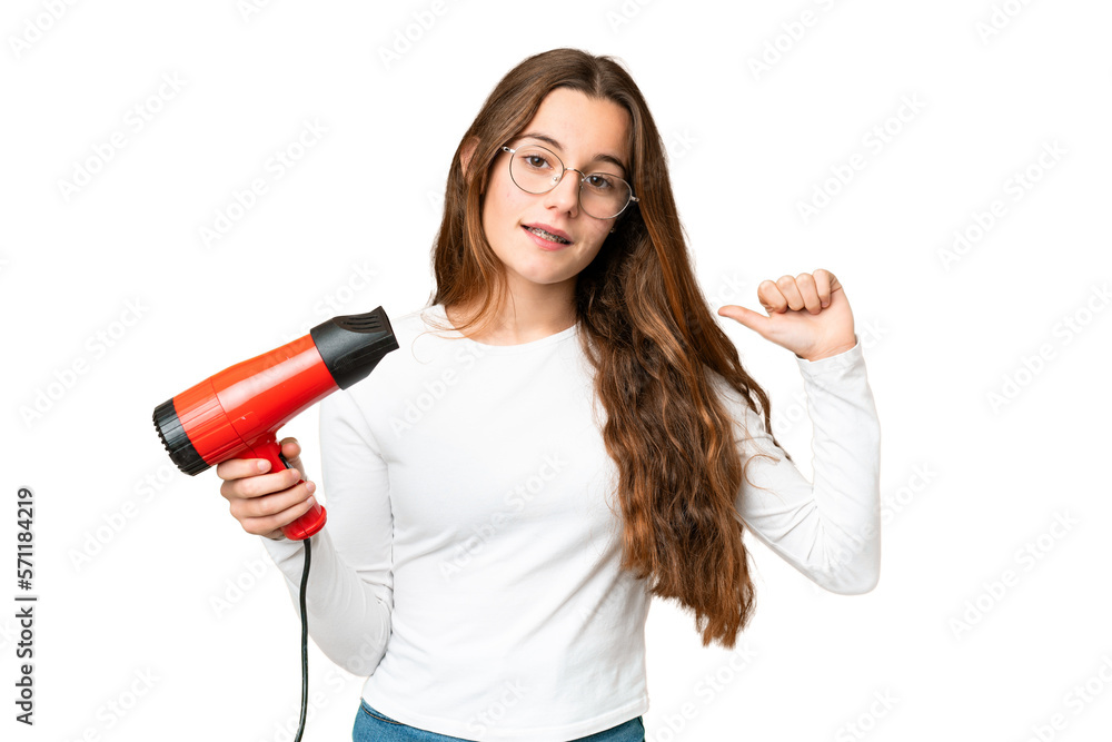 Teenager girl holding a hairdryer over isolated chroma key background proud and self-satisfied