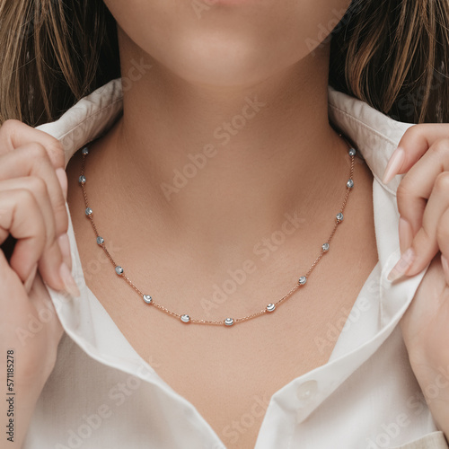 Woman Jewelery concept. Woman hands close up wearing rings, earrings and necklace modern accessories elegant life style. photo