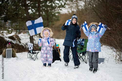 Εκτύπωση καμβά Three finnish children with Finland flags on a nice winter day