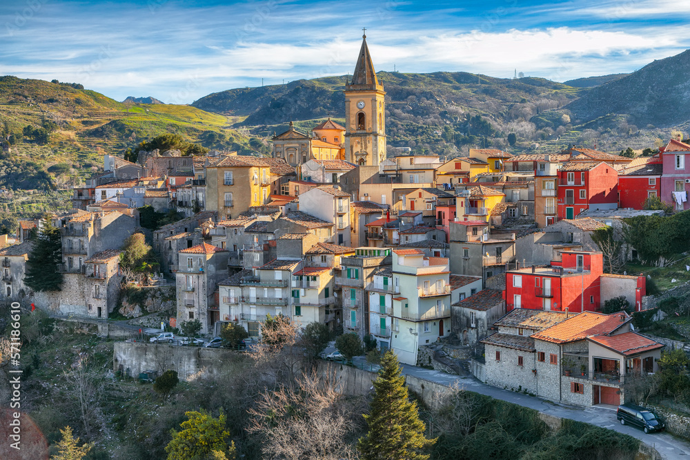 Amazing Panorama of the belltower and the village in the valley at early sunrise.