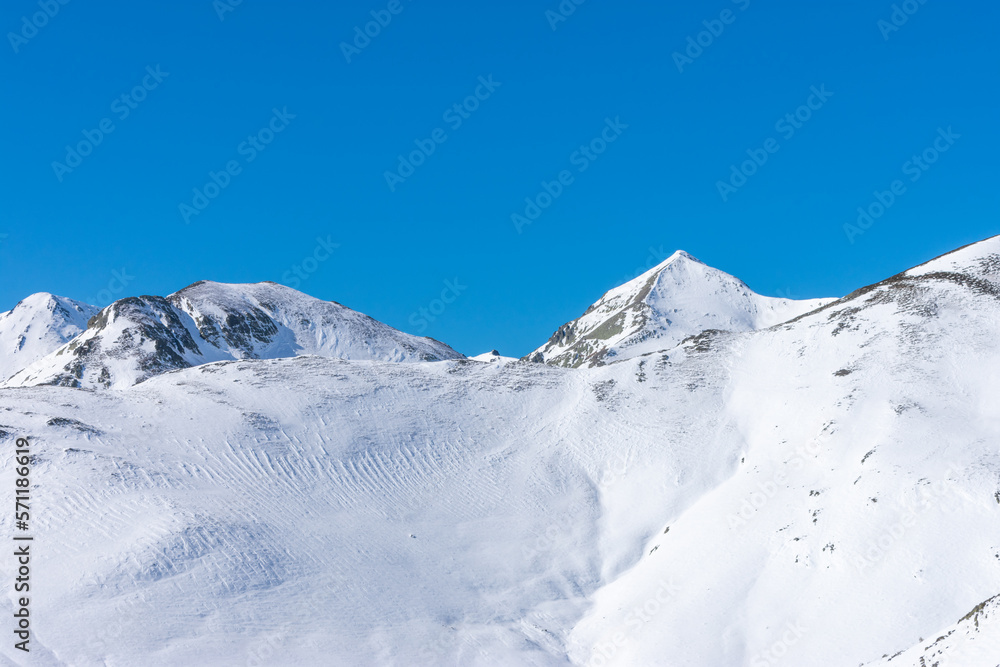 beautiful mountains with snow under the blue sky