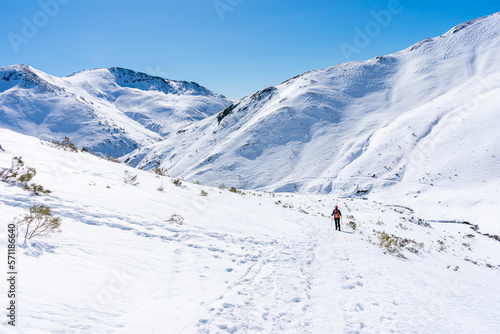 snowshoe mountaineer descends path into snowy mountains © photointruder