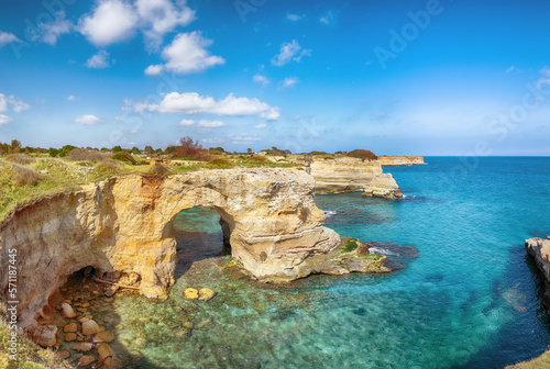 Stunning seascape with cliffs rocky arch and stacks (faraglioni) at Torre Sant Andrea © pilat666