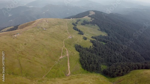 Aerial 4k video (Ultra High Definition) of Menchul mountain range. Fresh green view from flying drone of Carpathian mountains, Ukraine, Europe. Beauty of nature concept background.. photo