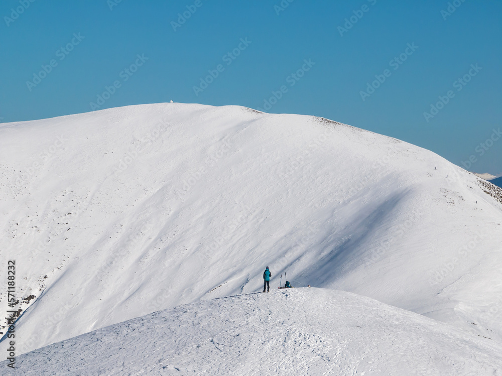 Lonely mountaineer among snowy mountains Lonely mountaineer among snowy mountains
