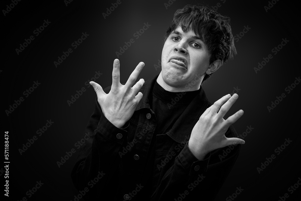 crazy young man with awesome hairdo grimacing crazy young man with awesome hairdo grimacing