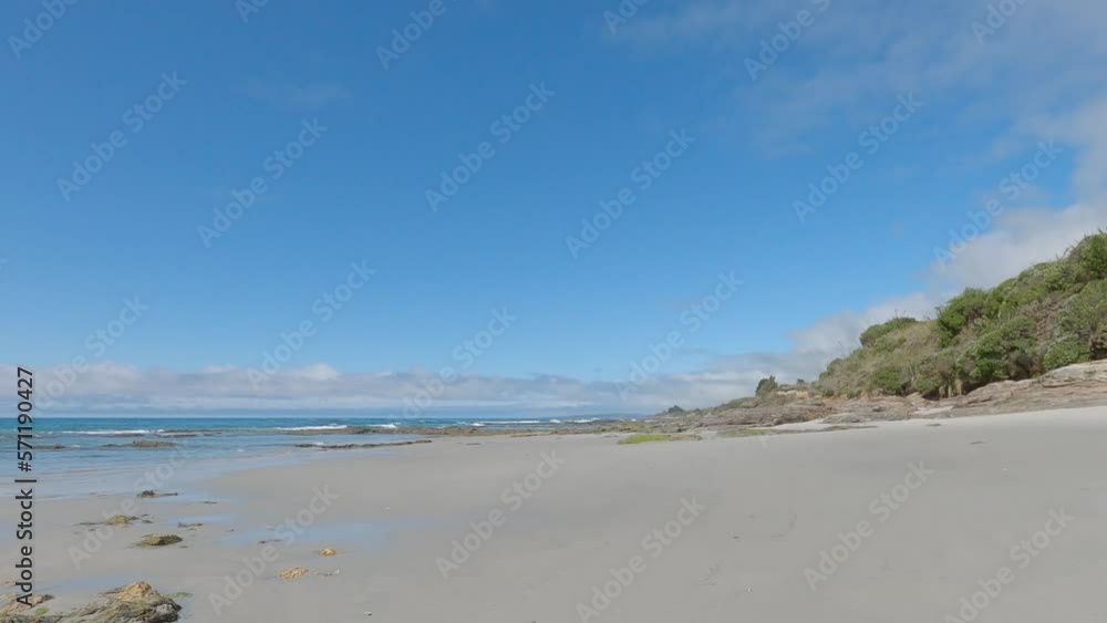 POV off-road cycling through low-lying coastal rocks on beautiful white-sand beach in summertime (Brighton Beach, New Zealand) POV off-road cycling through low-lying coastal rocks on beautiful white-sand beach in summertime (Brighton Beach, New Zealand)