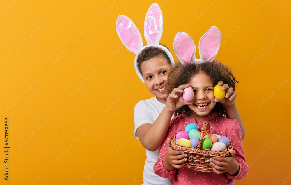 A happy children with rabbit ears on her head with a basket full of Easter eggs A happy children with rabbit ears on her head with a basket full of Easter eggs