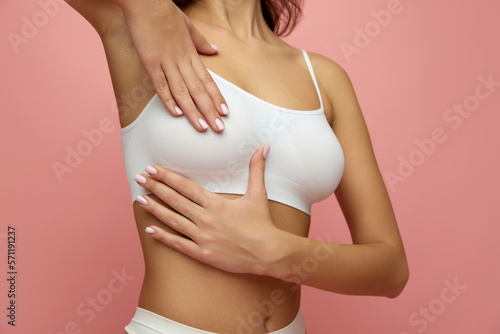 Wallpaper Mural Women's health. Cropped image of female body, breast in white underwear isolated over pink studio background. Mammoplasty, health, beauty and fashion Torontodigital.ca