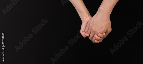 Holding hands gesture on black background
