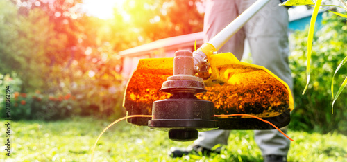 Cuadro en lienzo lawn mower mows grass with a grass trimmer