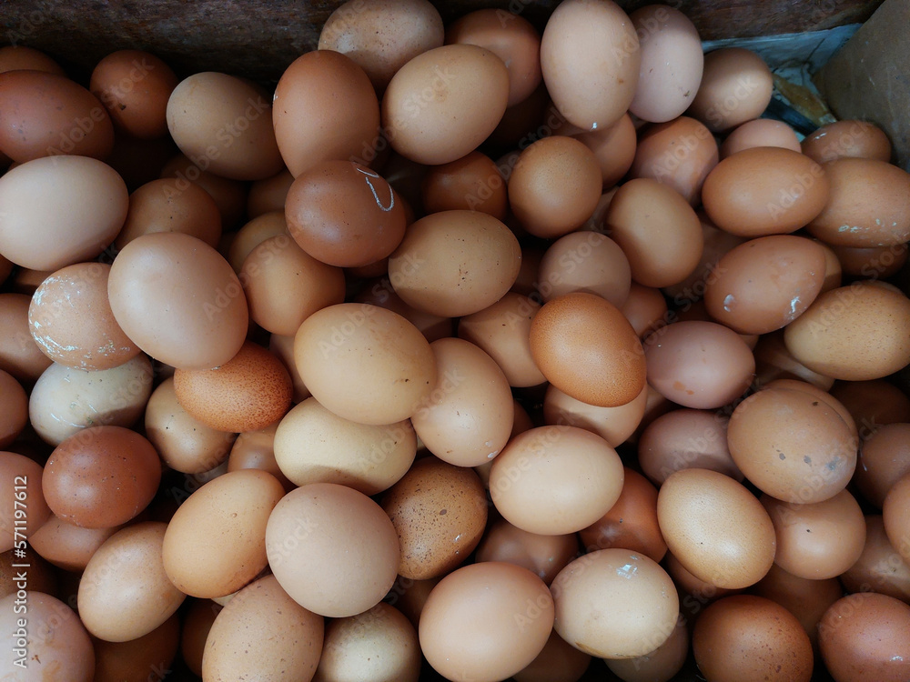 Raw brown chicken eggs pile as background flat lay view Raw brown chicken eggs pile as background flat lay view