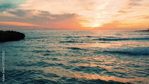 splendido tramonto sul mare in inverno, con le onde che si infrangono sulla spiaggia, marina di pulsano, salento, puglia, taranto , italia photo