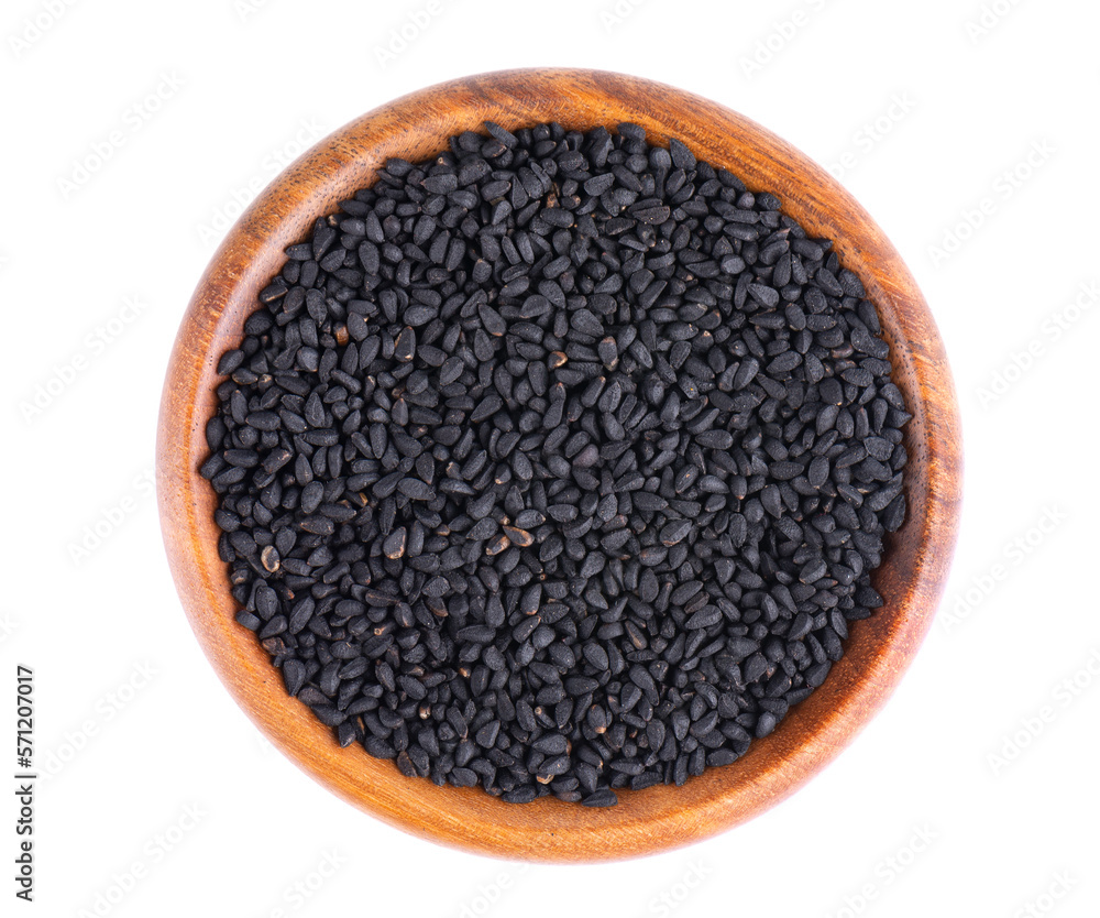 Black cumin seeds in wooden bowl, isolated on white background. Heap of black nigella seeds. Nigella sativa. Top view. Black cumin seeds in wooden bowl, isolated on white background. Heap of black nigella seeds. Nigella sativa. Top view.