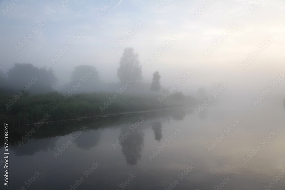 Morning rural landscape with fog over the river.