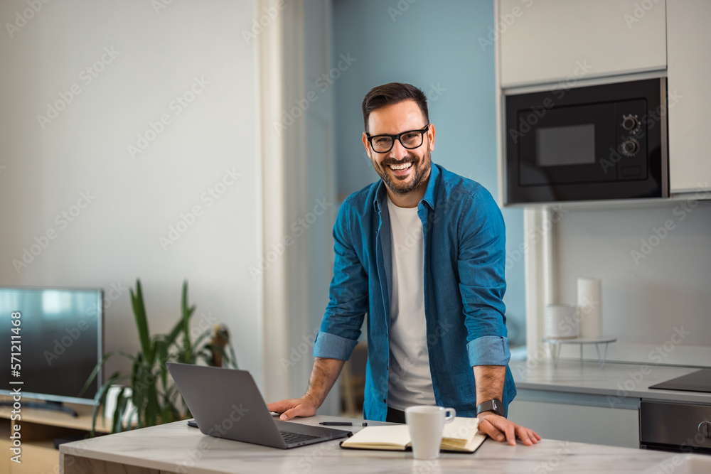 Portrait of a smiling man, standing at the home office, with glasses on. Portrait of a smiling man, standing at the home office, with glasses on.