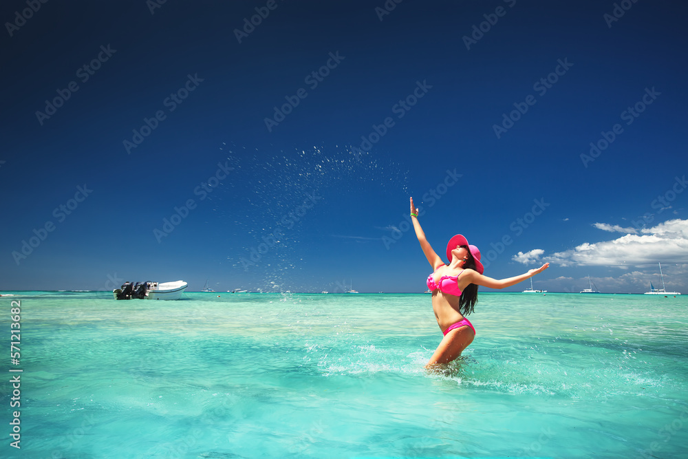 Carefree young woman relaxing on tropical beach in Dominican Republic