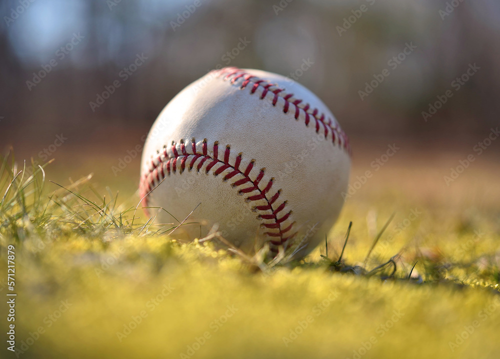 Closeup of a used baseball with red stitching