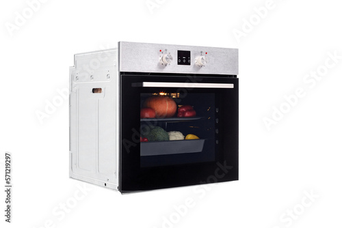 Electric oven with a closed door and an electronic panel, with vegetables for baking inside