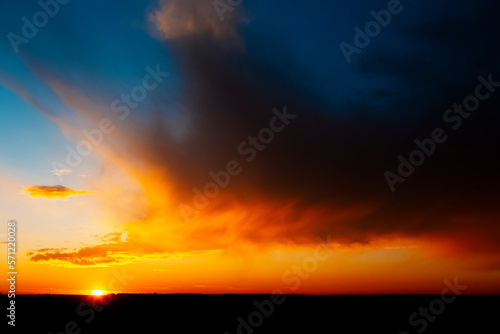 Colourful landscape of beautiful sunset with dark clouds.