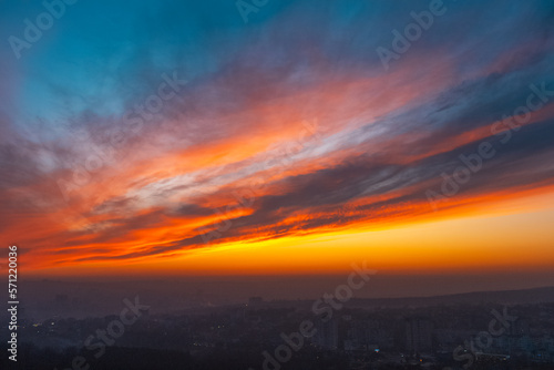 Colourful landscape of beautiful sunset above the night city.