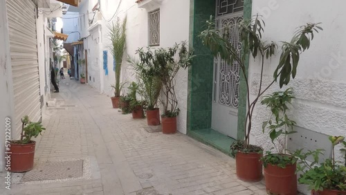 POV Walking Along Quaint Narrow Street In Tangier Medina Past Garden Pot Plants Lining Street