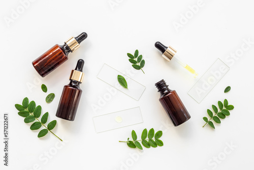Bottle with dropper lid and herbs - cosmetic serum essential oil