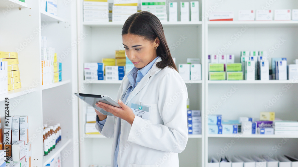 A young female pharmacist stocktaking in a dispensary using a tablet. Doctor preparing prescriptions and medication at clinic or pharmacy. Healthcare professional sorting medicine with digital device A young female pharmacist stocktaking in a dispensary using a tablet. Doctor preparing prescriptions and medication at clinic or pharmacy. Healthcare professional sorting medicine with digital device