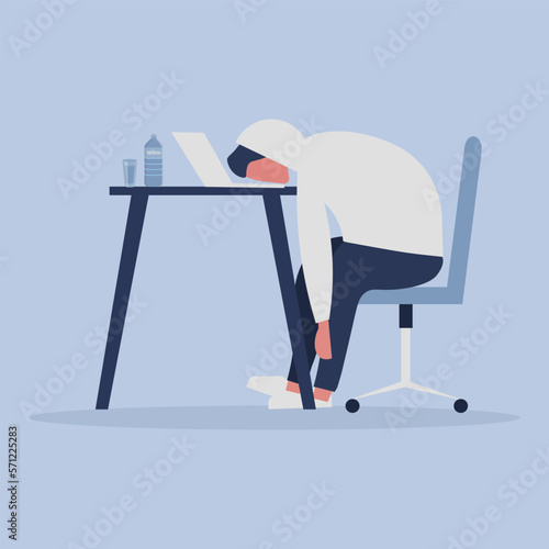 burnout syndrome. An exhausted guy sits with his head down on his laptop