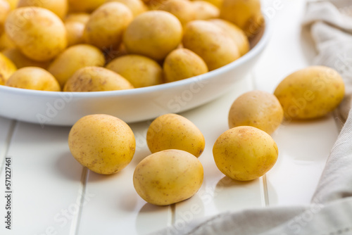 Raw Organic Golden Potatoes in Bowl  prepared for cooking