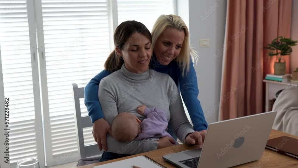 Young mother working from home while breastfeeding toddler - Loving moms and baby indoor - Family and work concept Young mother working from home while breastfeeding toddler - Loving moms and baby indoor - Family and work concept