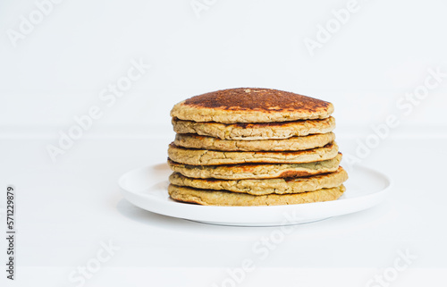 Freshly cooked soft delicious gluten free pancakes stacked on white plate. Space for text. Healthy sweet food.