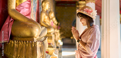 thai woman praying and making wai at wat arun temple in bangkok thailand