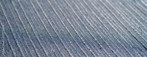 Cotton textile blue material close-up abstract defocused background.