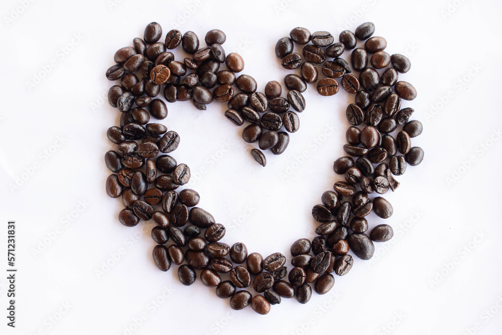 Coffee beans in the shape of a heart on a white background Coffee beans in the shape of a heart on a white background