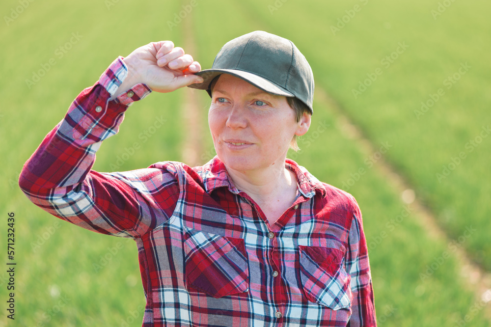 Portrait of female farmer in cultivated wheat seedling field Portrait of female farmer in cultivated wheat seedling field