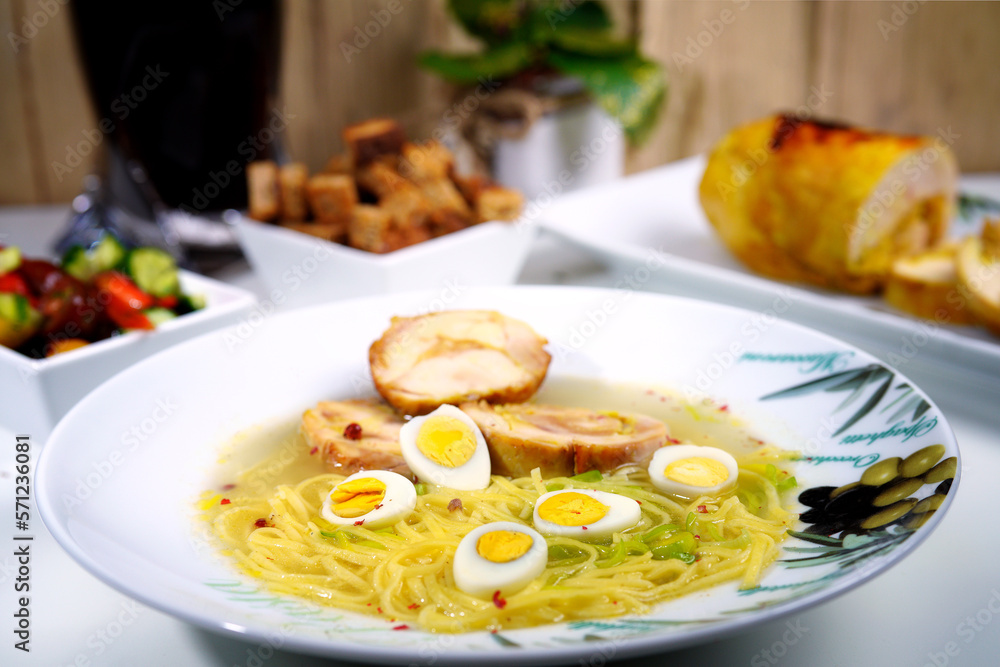 Soup with homemade noodles and quail eggs. Homemade food.