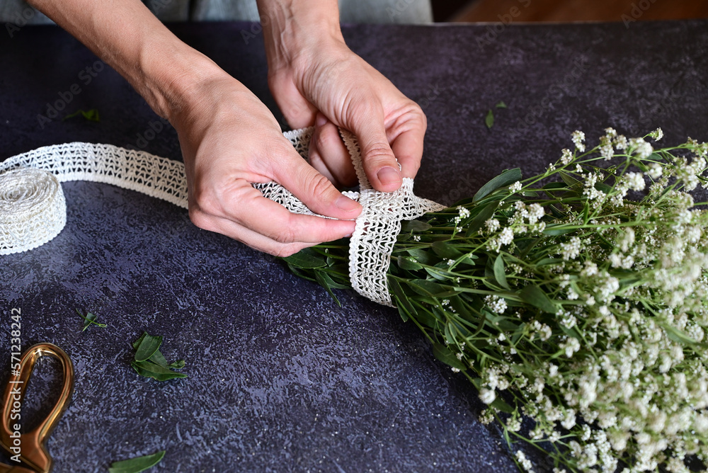 Florist at work. How to make gypsophila paniculata wedding wreath, step