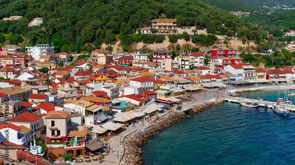 Parga town, Greece : 01 June 2023 : small colorful greek village or town view  on sea line, hotels, beach  cafes, berth for ferries and anchorage spot