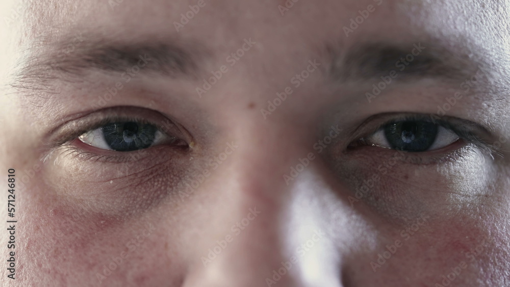 Person closing eyes in meditation and opening looking at camera. Macro close up of calm man eye in contemplation Person closing eyes in meditation and opening looking at camera. Macro close up of calm man eye in contemplation