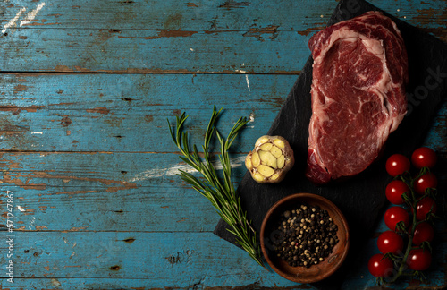 Variety of Raw Black Angus Prime meat steaks Machete, Blade on bone, Striploin, Rib eye, Tenderloin fillet mignon on wooden board copy space. High quality photo