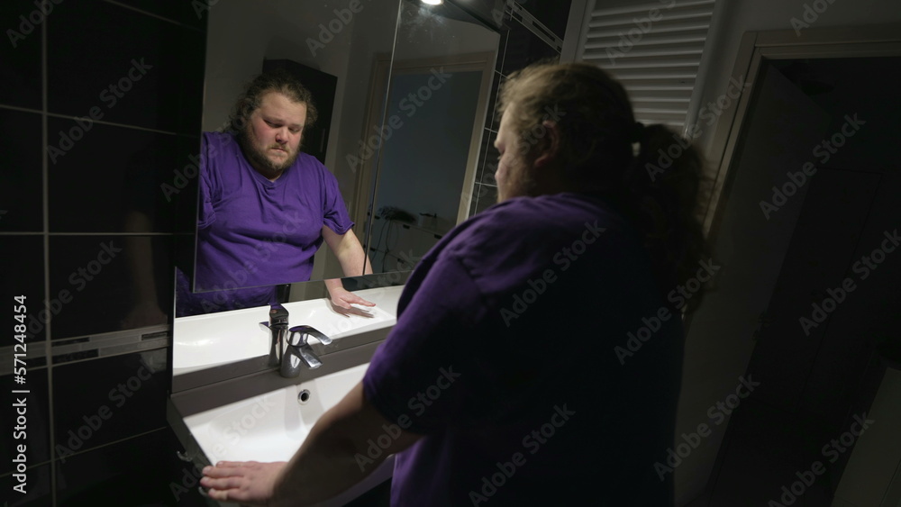 Confused sad man leaning on bathroom sink in dilemma and doubt. Person suffering from mental illness Confused sad man leaning on bathroom sink in dilemma and doubt. Person suffering from mental illness