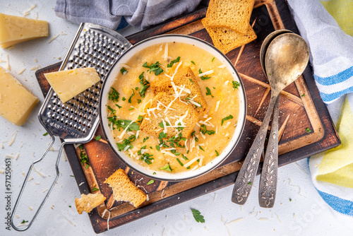 Tableau sur toile Homemade cheese cream soup, cheddar parmesan soup with croutons and greens, on w