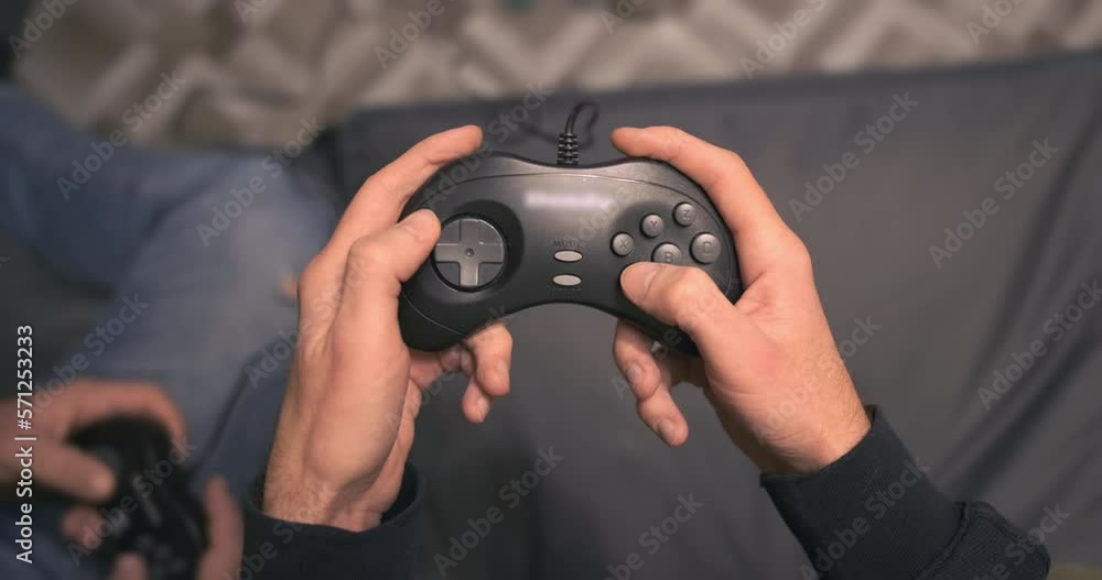 Close up, retro game joystick in hands, top view. Men playing retro