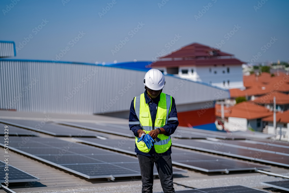 Technology solar cell, Engineer service check installation solar cell on the roof of factory. technician checks the maintenance of the solar panels Technology solar cell, Engineer service check installation solar cell on the roof of factory. technician checks the maintenance of the solar panels
