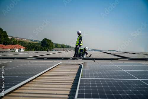 Technology solar cell, Engineer service check installation solar cell on the roof of factory. technician checks the maintenance of the solar panels