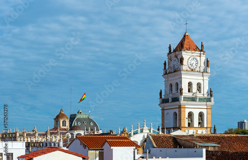 Cathedral tower of Sucre and cityscape with bolivian flag, Chuquisaca department, Bolivia. photo