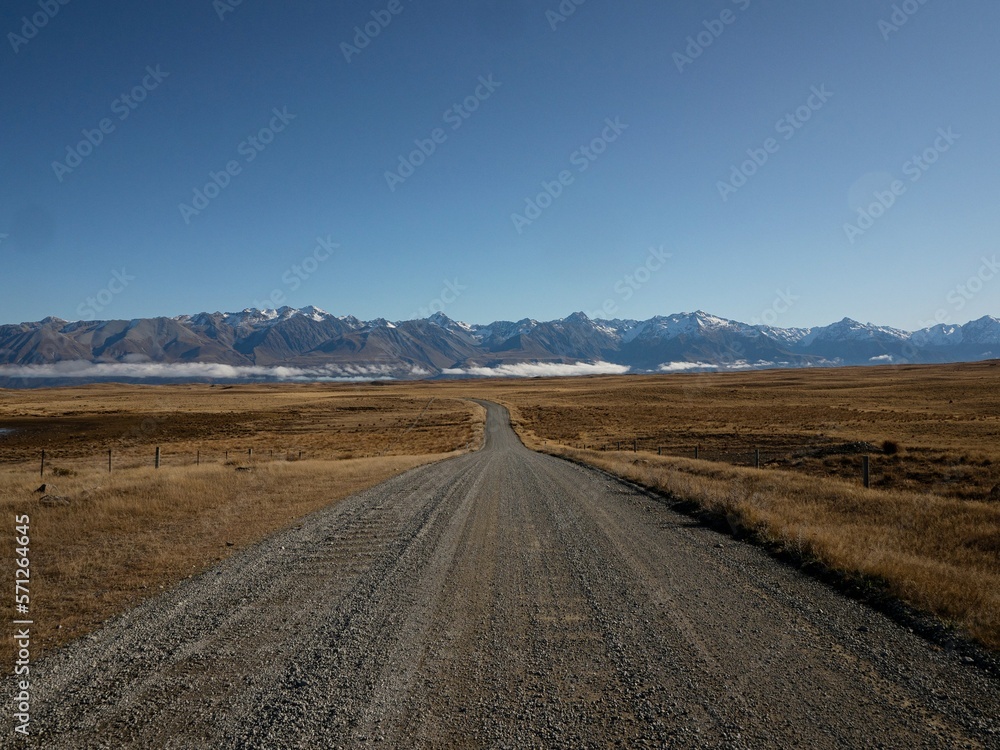Dirt gravel Braemar Road leading to Lake Pukaki, Southern Alps mountain nature landscape panorama Canterbury New Zealand