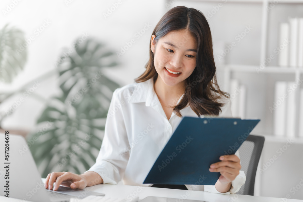 Attractive pretty asia businesswoman working with balance sheet, doing math in financial contract of company Attractive pretty asia businesswoman working with balance sheet, doing math in financial contract of company